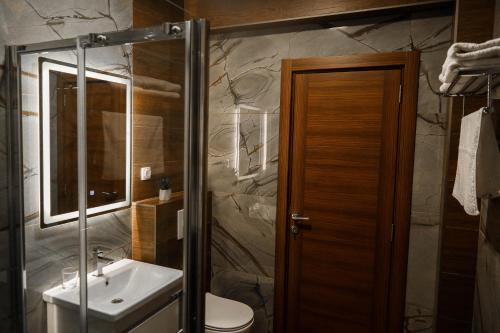 a bathroom with a sink and a toilet at S Apart Rooms in Bosanska Gradiška