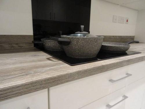 two bowls sitting on a counter in a kitchen at Magnolia Palace/Group Long Stays in Killingbeck