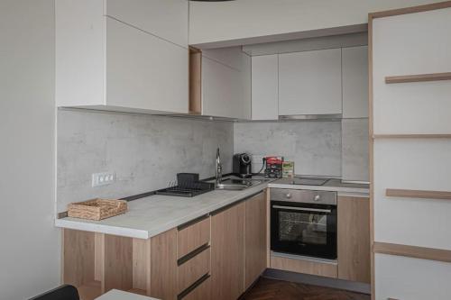 a kitchen with a sink and a stove top oven at Central Apartment in Varna in Varna City