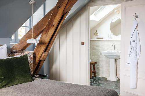 a bathroom with a bed and a sink at Domaine de Locguénolé & Spa - Relais & Chateaux in Kervignac