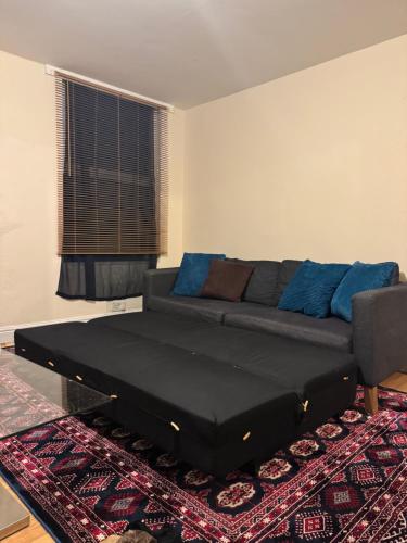 a living room with a couch and a rug at Flat 71 in Bristol