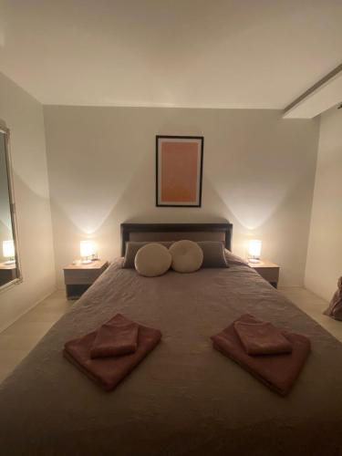 a bedroom with a large bed with two towels on it at Apartman Rose in Kruševac
