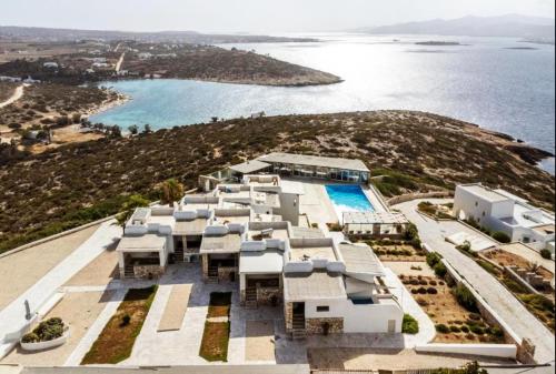an aerial view of a resort with a pool and the ocean at Irenes View Apartments in Agia Irini Paros