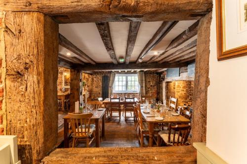 a restaurant with wooden floors and tables and chairs at The White Horse, Rogate in Petersfield
