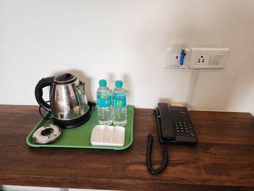 a tray with two bottles of water and a telephone at Hotel ksp kings inn in Bangalore