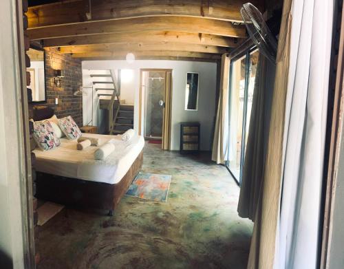 a bedroom with a bed in the middle of a room at Athule Inn Marloth - Units in Marloth Park