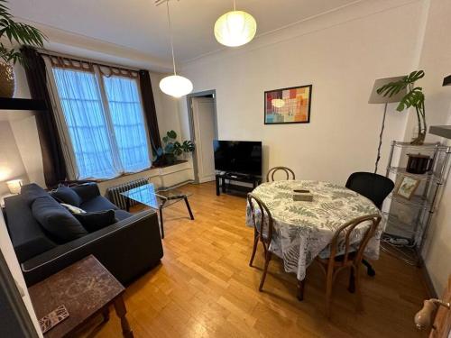 a living room with a couch and a table at Next to Paris Metro - Calm & Convenient Apartment in Villejuif