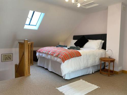 a bedroom with a large bed and a window at Oaklands Cottage on a rural farm in Dingestow