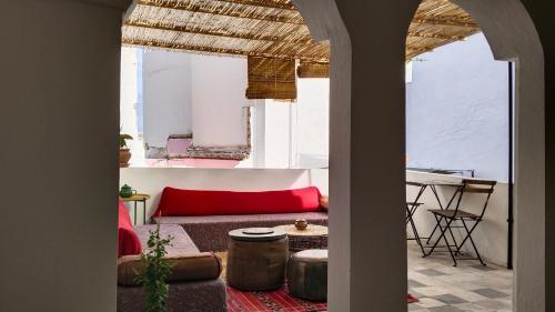 a living room with a red couch and a table at Dar Gara in Tangier