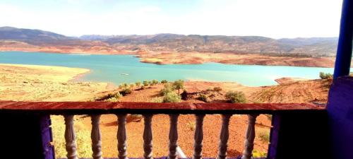 a view of a lake from a balcony at Magic View in Bine el Ouidane