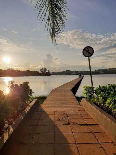 a boardwalk leading into a lake with a clock on it at FRAN's - HOSPEDAGENS in Lagoa Santa