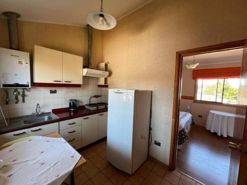a kitchen with a refrigerator and a table in it at El Mirador De Valparaiso in Valparaíso