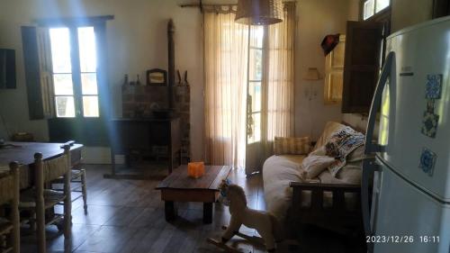 a dog is standing in a living room with a table at Casa De Campo El Corral in Carmen de Areco