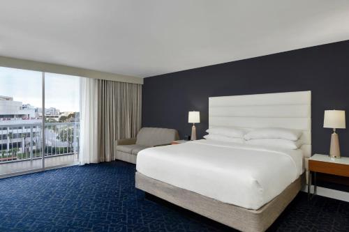 a bedroom with a large white bed and a window at Hotel Tampa Riverwalk in Tampa