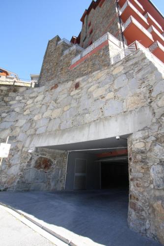 a large stone building with a garage at Altissim Tarter - Inclès - Ransol in El Tarter