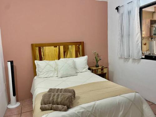 a bedroom with a bed with a blanket on it at Mini depa perfecta ubicación! in Oaxaca City