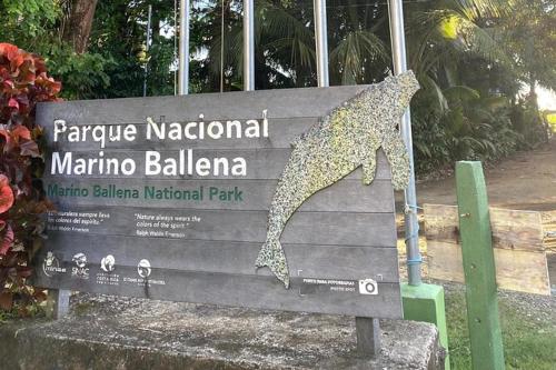 a sign for a zoo with a dog on it at Casitas Del Rio Riverfront Nature Lodge in Uvita
