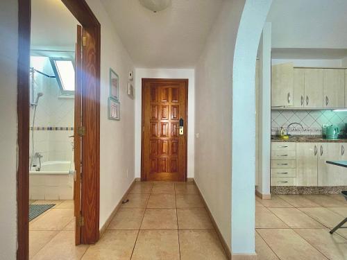 un corridoio di una cucina con porta in legno di CASA VARGAS-TENERIFE a Los Cristianos