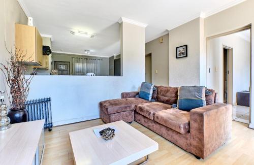 a living room with a couch and a table at Comfort Apartment SA in Johannesburg