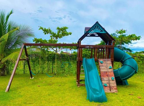 a playground with a slide and a play structure at Modern & convenient condo in Jaco downtown in Jacó