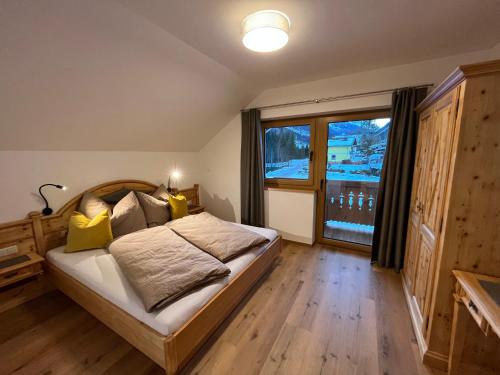 a bedroom with a bed and a large window at Haus Tennstein in Schladming