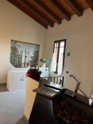 a room with a fireplace and a painting on the wall at La Divina in SantʼAgata Bolognese