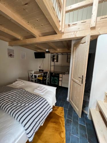 a loft bedroom with a bed and a desk at M3 Mád in Mád