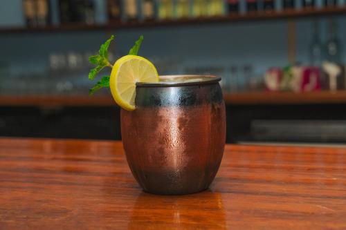 a brown cup with a lemon on top of a table at Hotel El Cocobolo Food&Rest Room 3 B&B WiFi AC Pkg Free Swimmingpool in Liberia