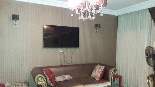 a living room with a couch and a television at شقه مفروش في التجمع الخامس in Cairo