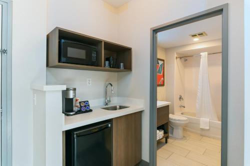 a bathroom with a sink and a toilet at Quality Suites London in London