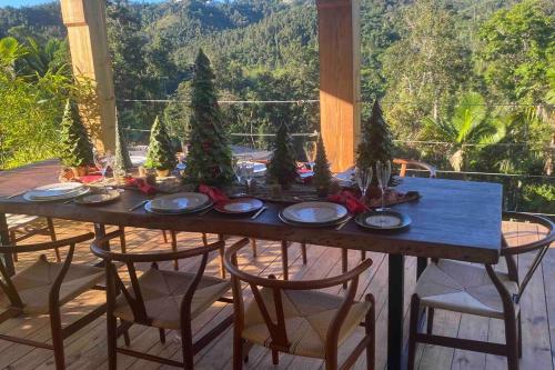 a table with christmas trees on it on a porch at Casa de Paz in Guayama