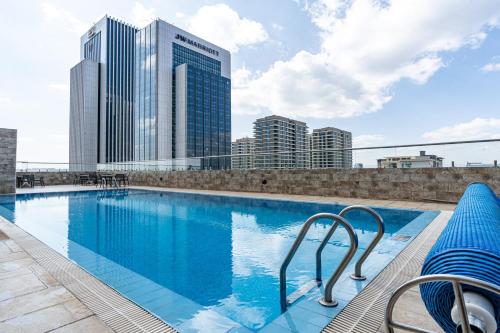 a swimming pool on the roof of a building with tall buildings at Elite One Bedroom Apartment,Swimming pool, gym, workspace ,Wonderiss Homes Westland Living in Nairobi