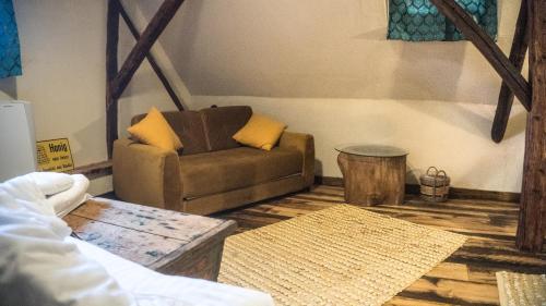 a living room with a couch and a table at Michelsberger Haus in Cisnadioara