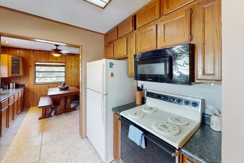 a kitchen with a white refrigerator and a stove at Fair Wind II in Tavernier
