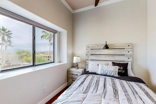 a bedroom with a bed and a large window at Desert Cottage in Fountain Hills