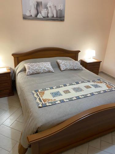 a bedroom with a bed with two pillows on it at Casa Marconi in Aragona