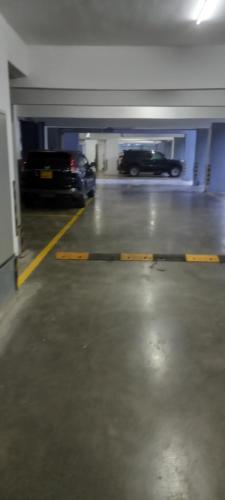 a parking garage with two cars parked in it at Staroot residencey in Nairobi