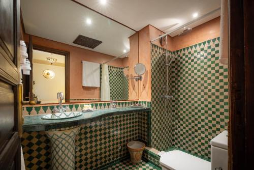 a bathroom with a sink and a shower at Riad Mazar in Fez