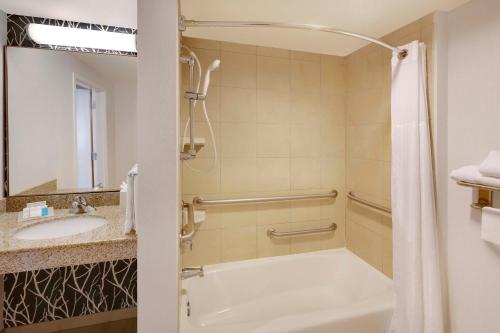 a bathroom with a tub and a sink at Hilton Garden Inn Austin North in Austin