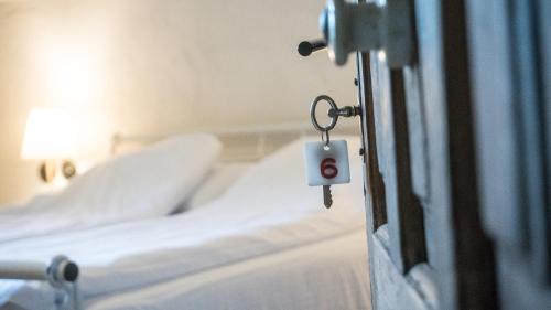 a room with two beds and a door with a key at Michelsberger Haus in Cisnadioara