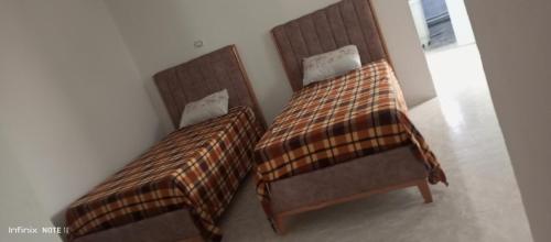 Ein Bett oder Betten in einem Zimmer der Unterkunft Dar ettawfik