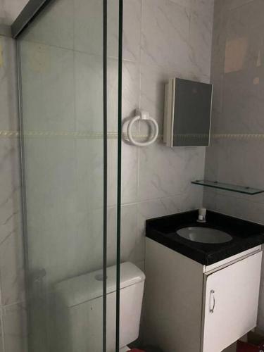 a bathroom with a shower and a toilet and a sink at Chalé em Praia Bela Paraíba in Pitimbu