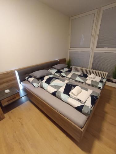 a bedroom with a large bed in a room at Spirit apartments Brno, with parking in Brno