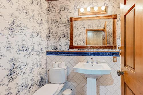 a bathroom with a toilet and a sink and a mirror at Cherry Heights in The Dalles