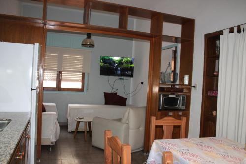 sala de estar con cocina y sala de estar con sofá en Departamento Santa Rosa en Córdoba