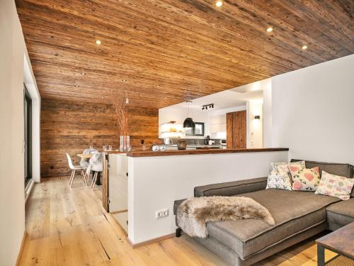 a living room with a couch and a kitchen at The Mountain Hideaway 211 by AA Holiday Homes SKI IN SKI Out Die Tauplitz in Tauplitz
