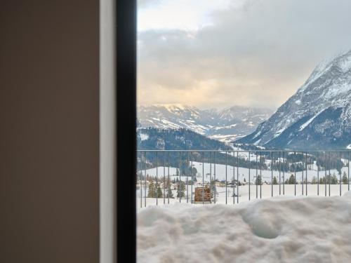 a view of a snowy mountain range from a window at The Mountain Hideaway 211 by AA Holiday Homes SKI IN SKI Out Die Tauplitz in Tauplitz