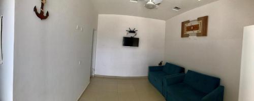 a hallway with two blue chairs in a room at Cantinho da Lili in Ubatuba
