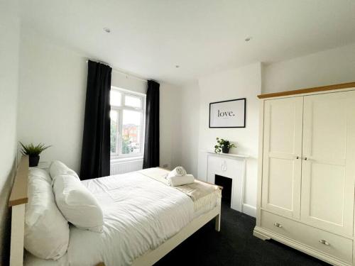 a bedroom with a white bed and a window at Solace in Bournemouth