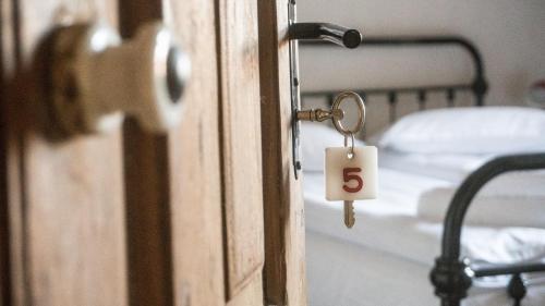 a door with a key in a room with a bed at Michelsberger Haus in Cisnadioara